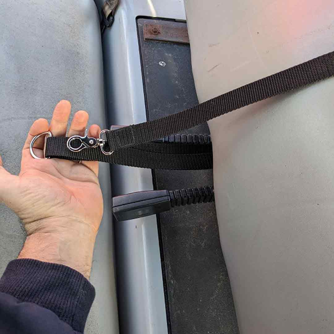 Person attaching tether to golf cart seat