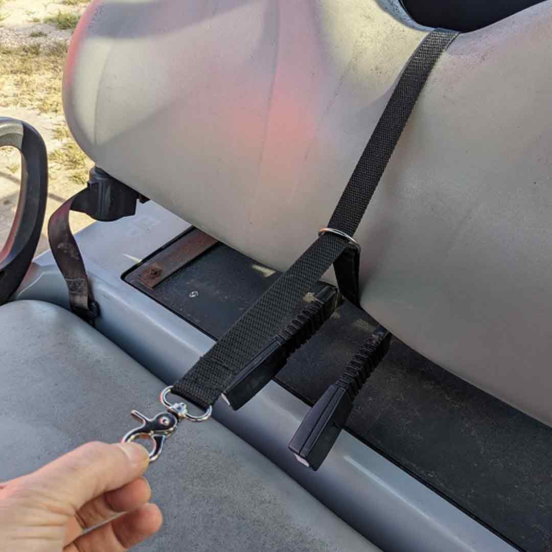 Person attaching tether to golf cart seat